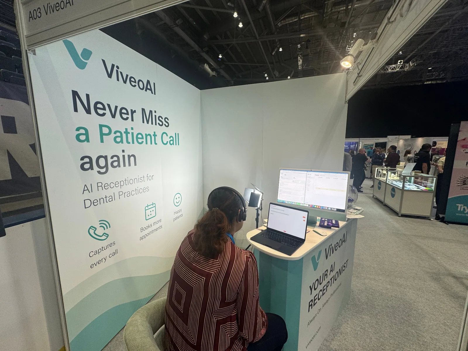 Dental professional trying the ViveoAI AI receptionist live demo at the Scottish Dental Show 2026