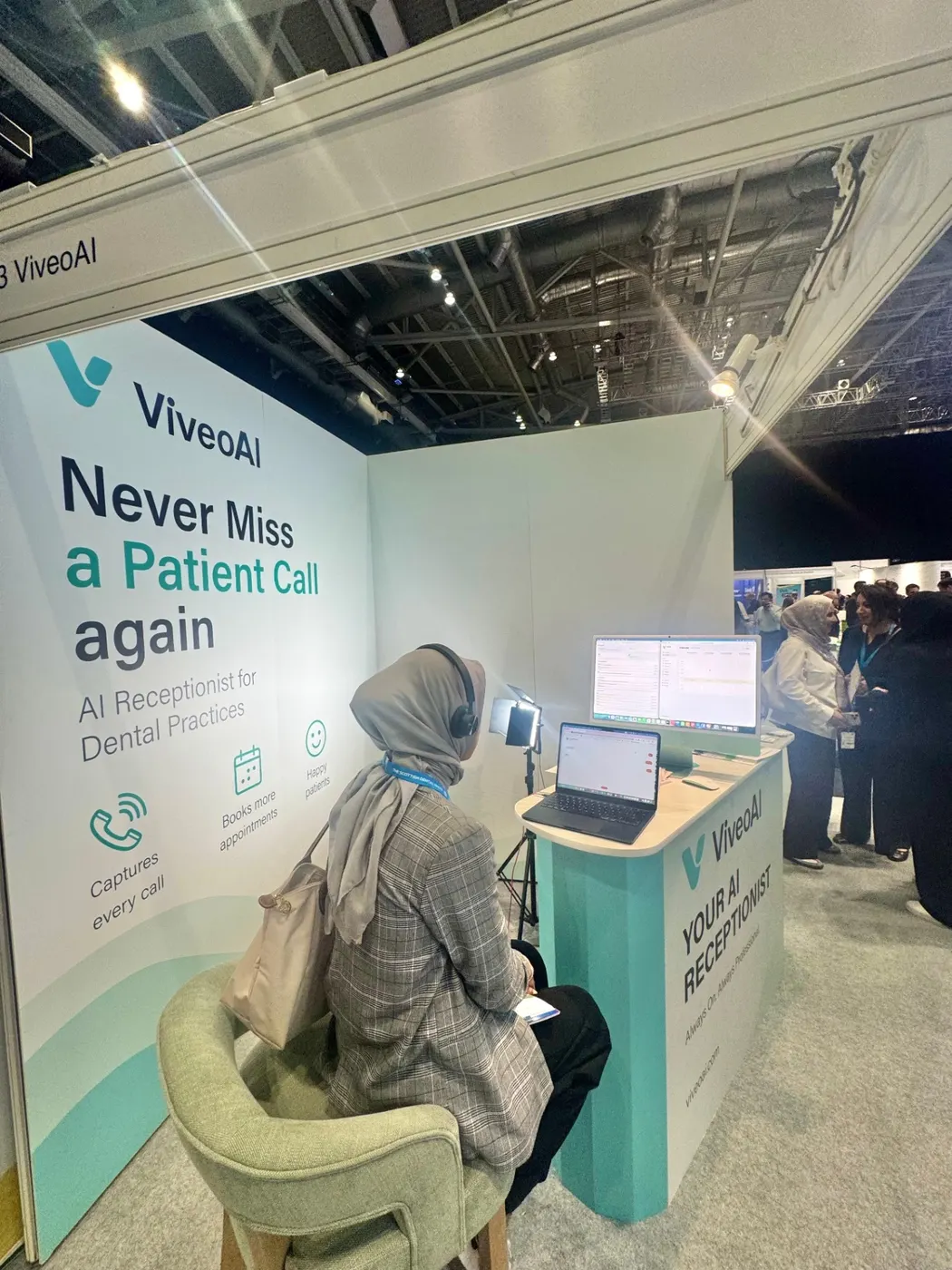 ViveoAI stand at the Scottish Dental Show 2026 with attendee trying the AI receptionist live demo